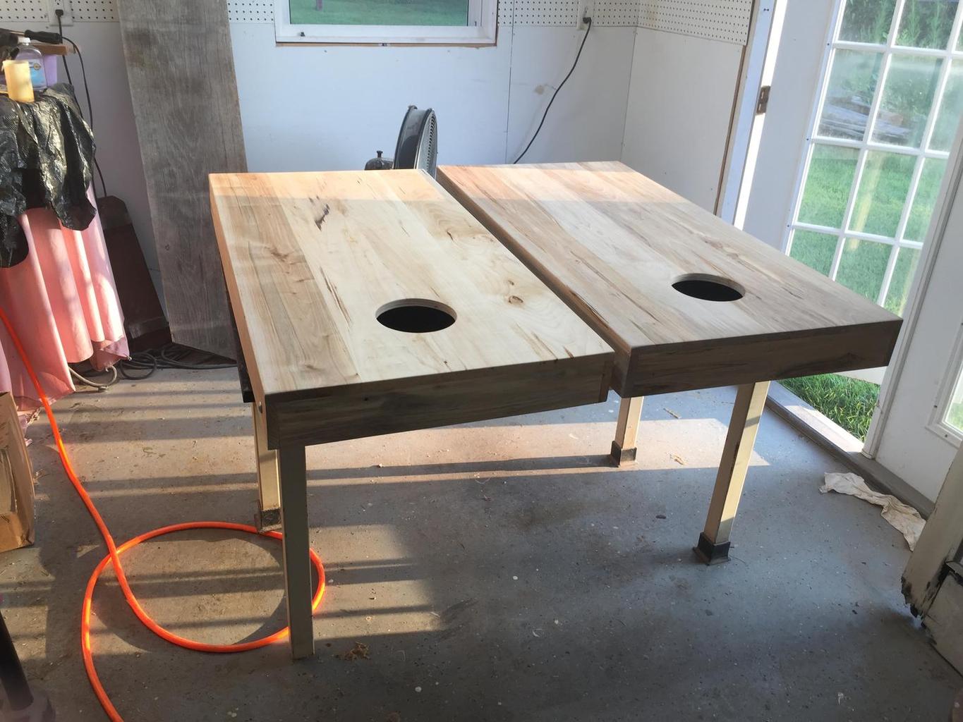 Corn hole boards being sprayed.JPG